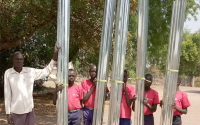 children with iron roofing sheets